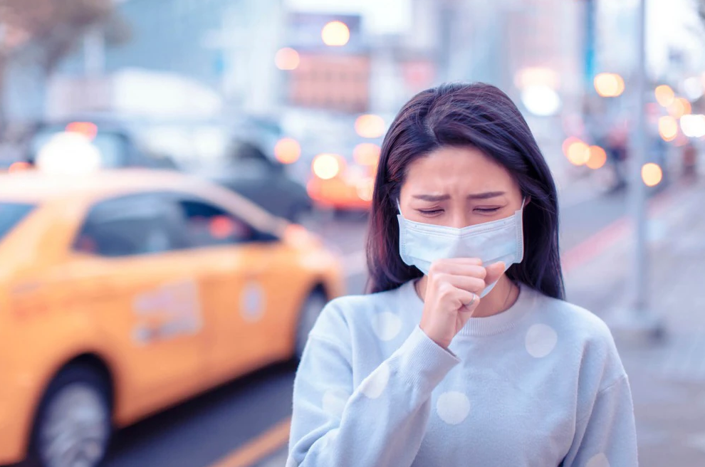Ein Mädchen, das durch den Smog in der Stadt nicht atmen kann